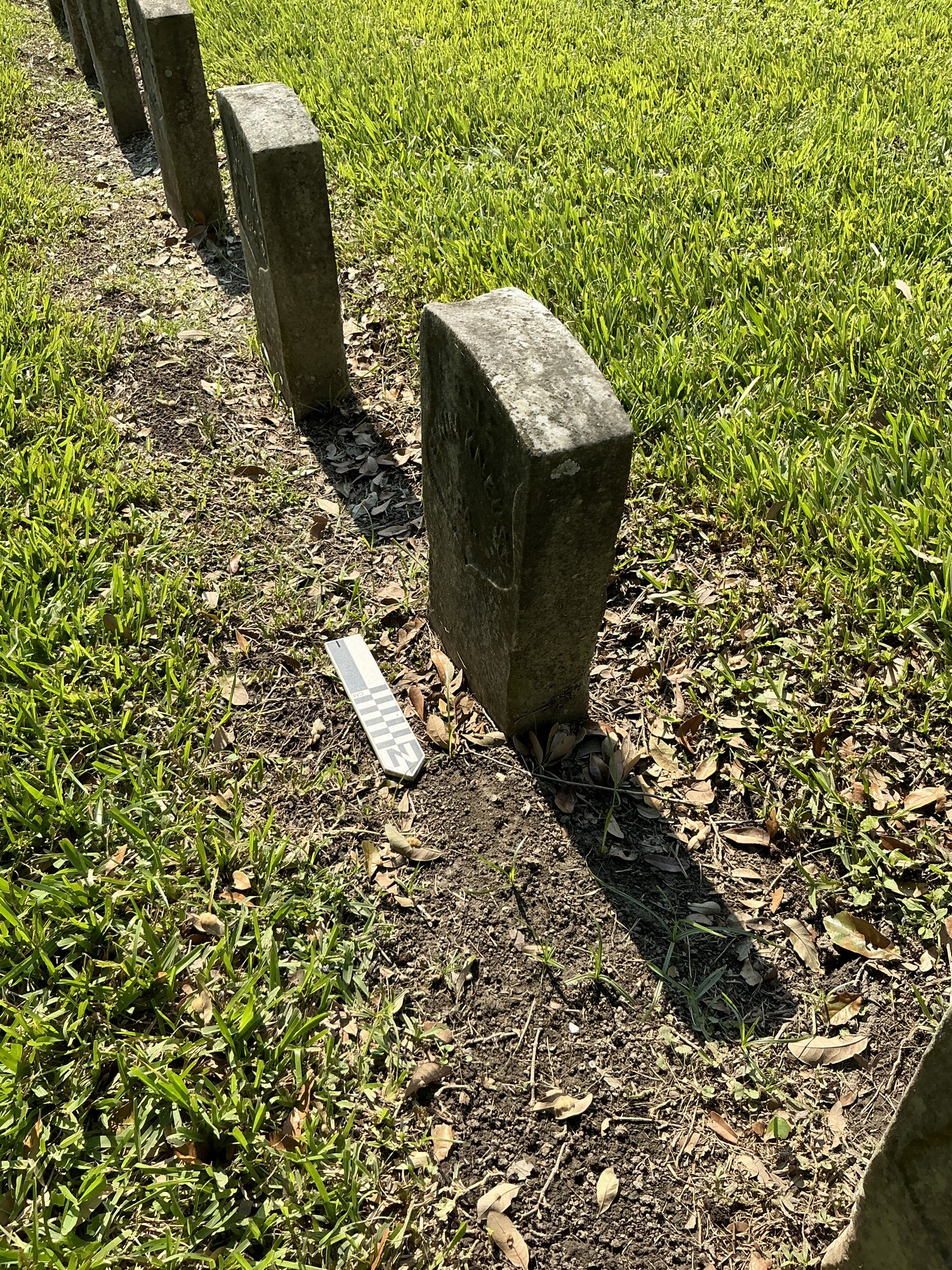 Extra image of historic upright marble headstone with recessed shield face.