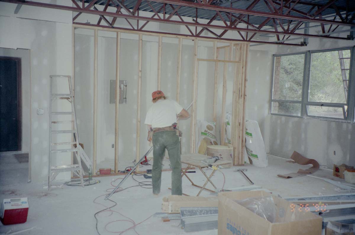 Man working on the construction of headquarters addition.