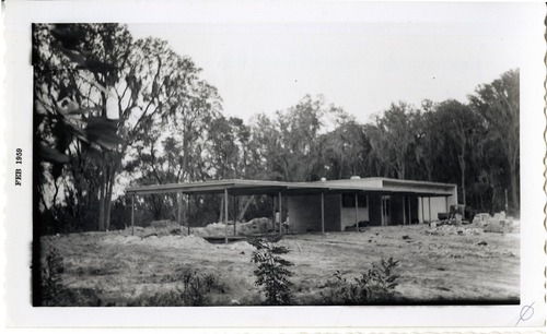 a black and white photo of a brick building under construction