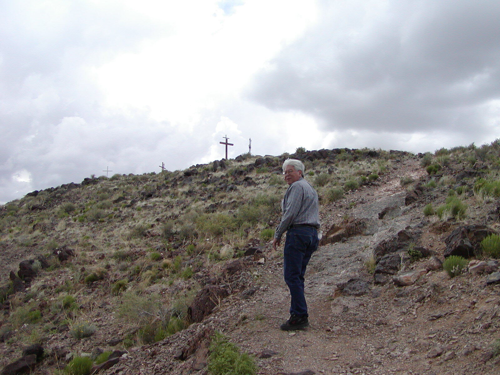 A man hikes the trail leading to El Cerro de Tome in Valencia County, NM