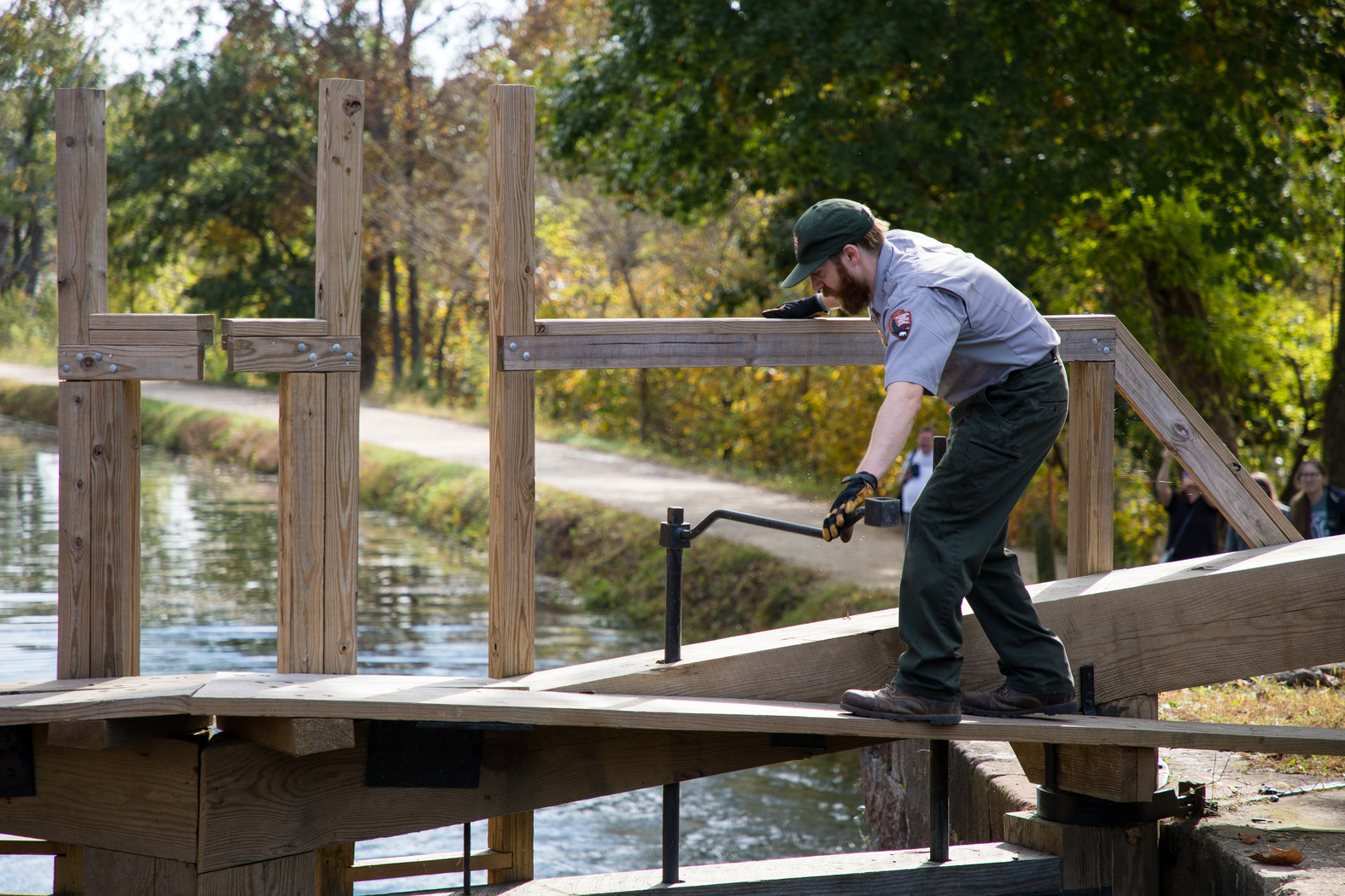 Park Ranger turning a lock key to let water out of the Lift Lock.