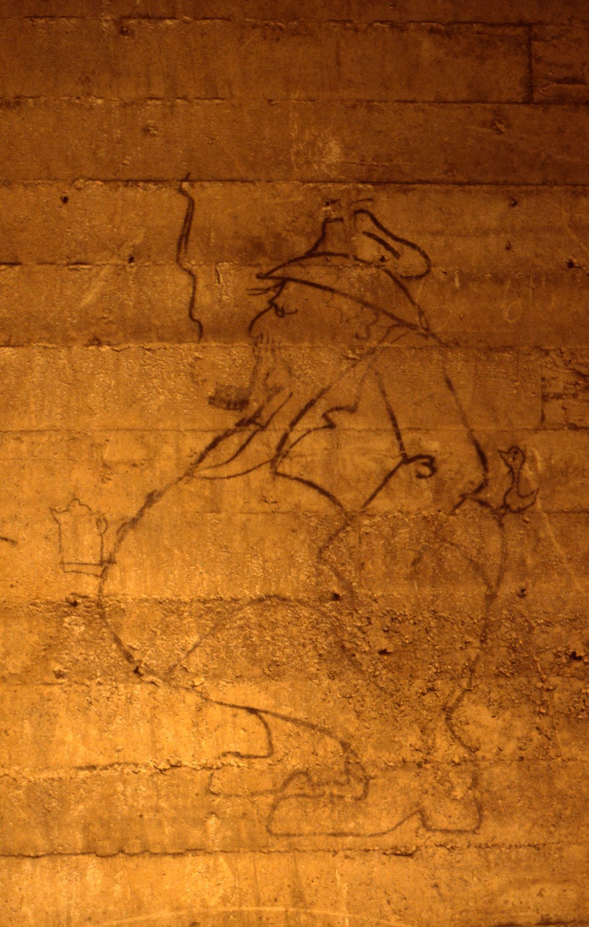 Graffiti of a construction boss caricature with a bird on his behind.