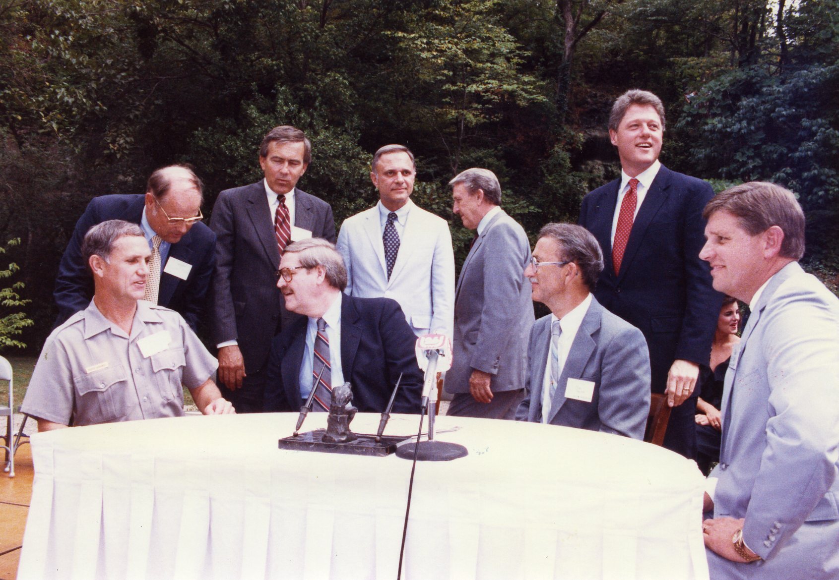  Melvyn Bell and Roger Giddings signing historic property lease.  Figures shown are Roger Giddings, Melvyn Bell, Tommy Robinson, David Pryor, Dale Bumpers, and Bill Clinton.  HOSP 23929 b and d have handwritten details written on reverse.  
