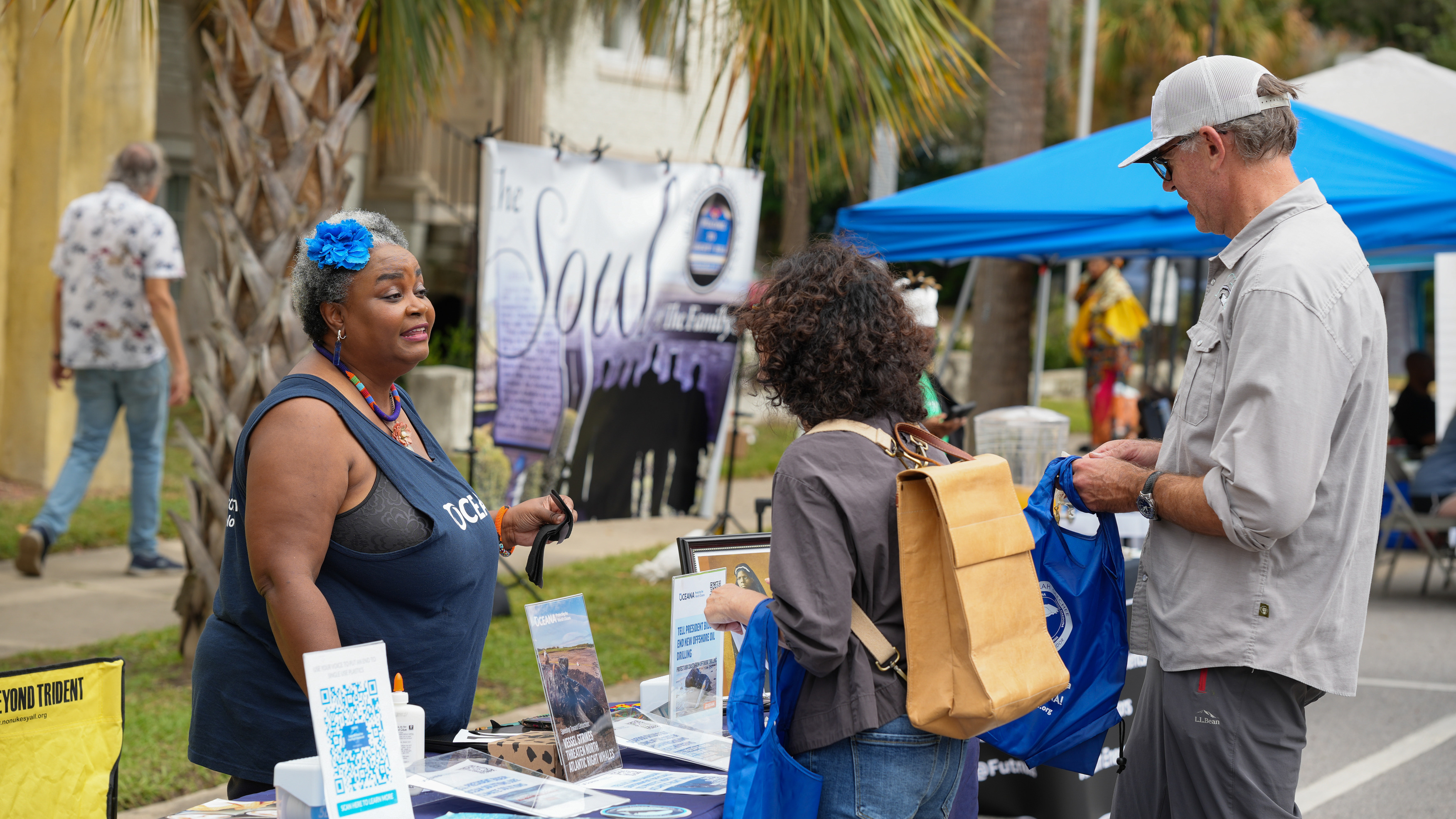 A group of people talk at a table about the organization Oceana.
