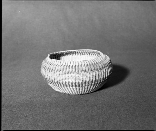 Marie Rozier Collection, Catalog No. 151. Object: Washoe coiled basket. Dimensions: 8 1/2 x 8 1/2 x 4 1/2". Materials: Willow and fern root, analine-dyed willow (red). Technology: Leftward coil direction, non-interlocking stitching, oval start made by bending willow rod. Collection History: Gift of Ora Doyle. Photographed by Michael Dixon, December 1982. Catalogued by Craig Bates and Barbara Beroza. Yosemite Collections, National Park Service.