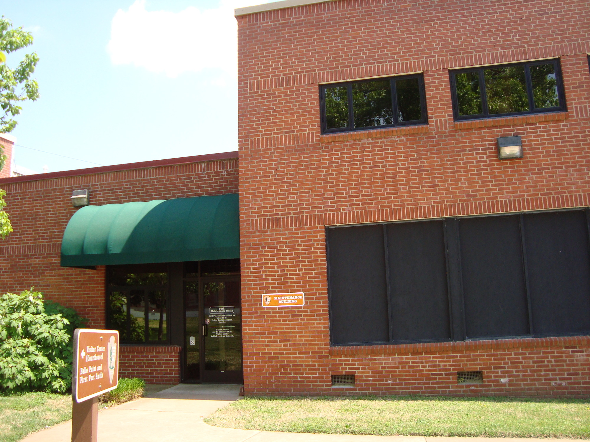 A brick building with a green awning.