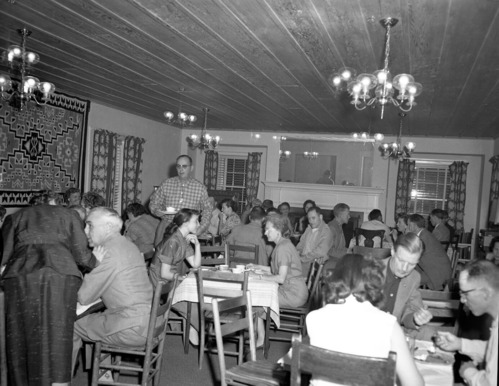 Men and women seated at tables in the ranger dormitory for Mr. and Mrs. Leland Allen's going away party. Allen accepted position in National Capitol Parks as GS-11 Naturalist.