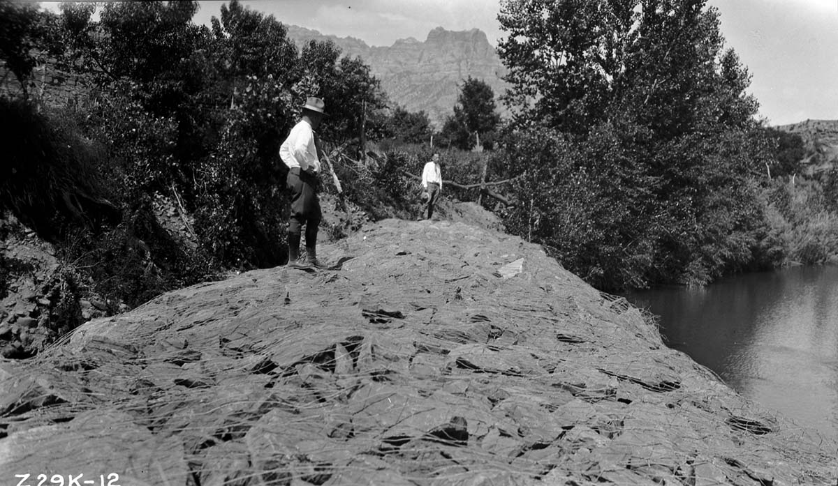 Two rangers inspecting the finished dike along the Virgin River in Rockville.