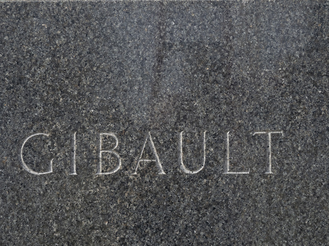 Inscription in black granite on the front of the statue's base: Gibault