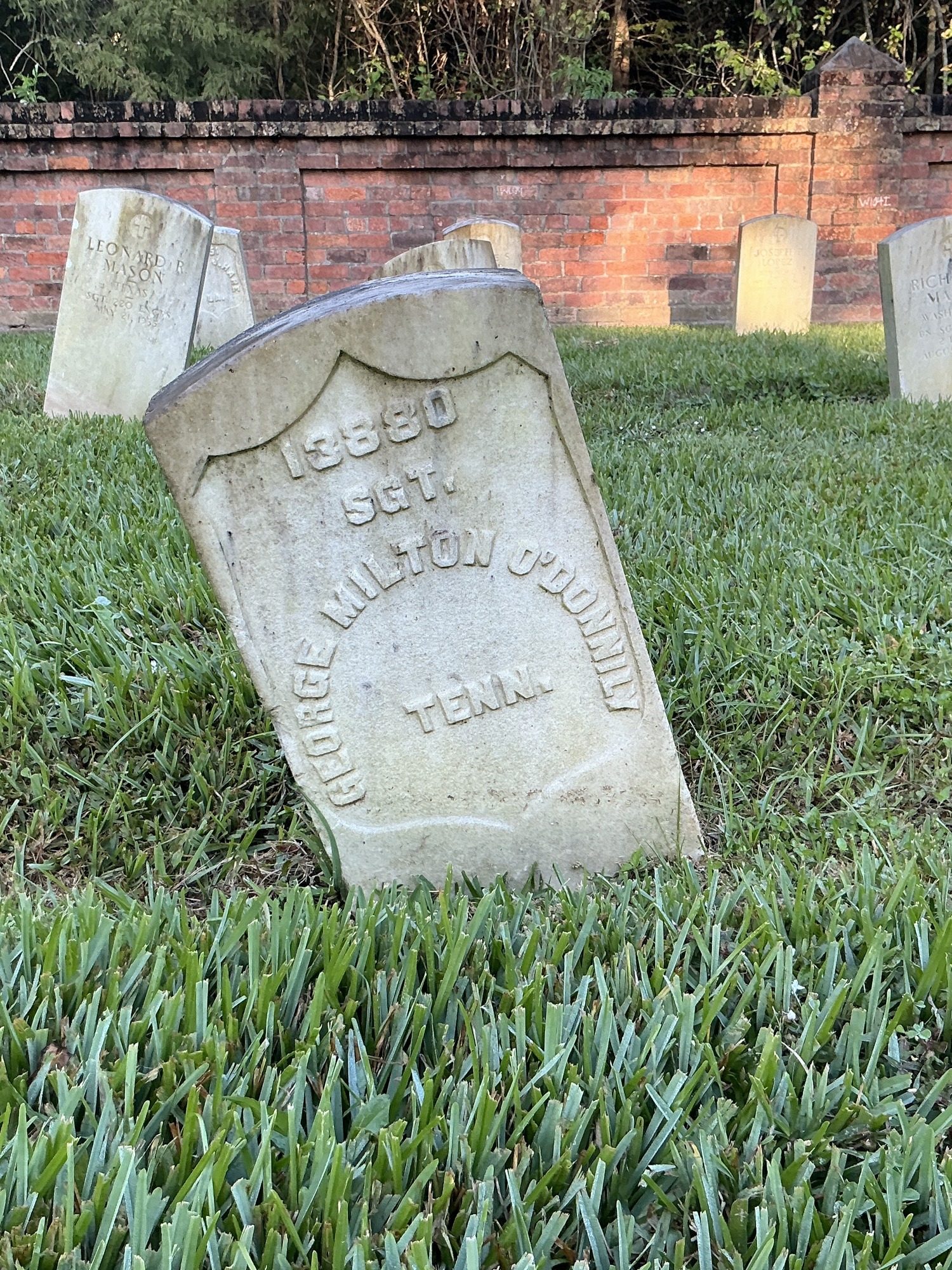 Front of historic upright marble headstone with recessed shield face.