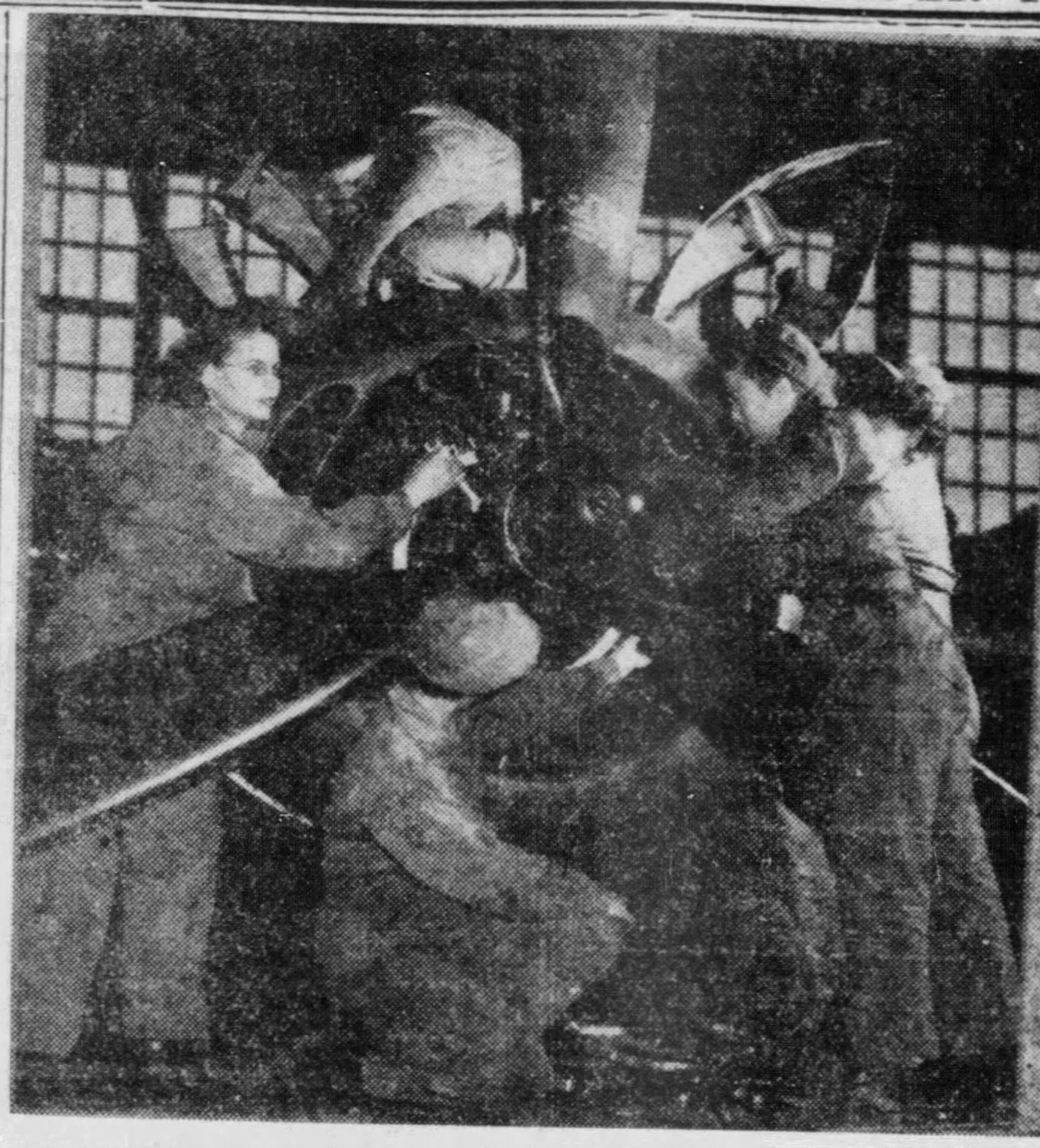 Black and white photo of several women working on a plane propeller