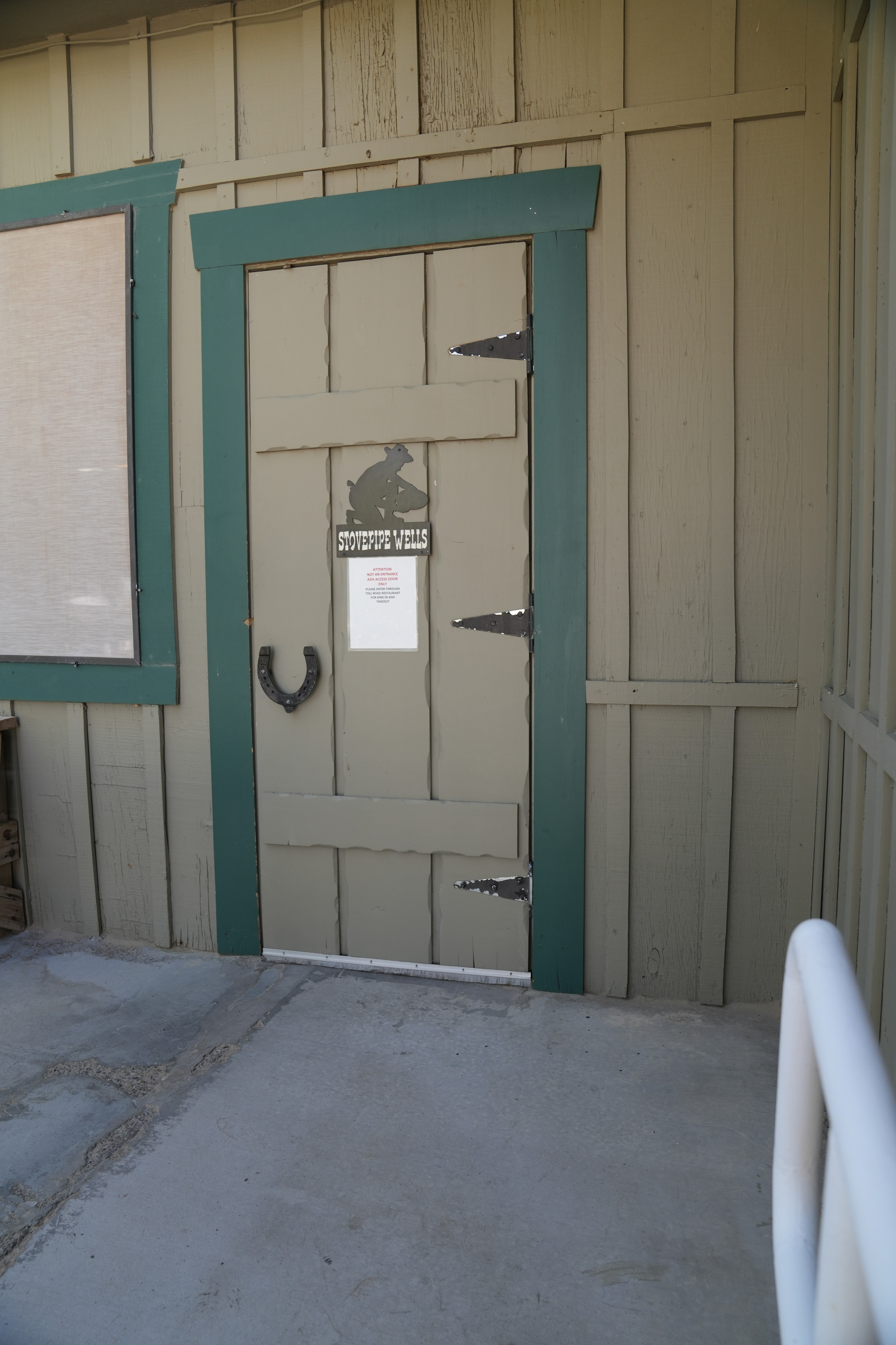 Stovepipe Wells restaurants' ramp entryway door. A single-door with a horseshoe handle. The ramps series leads to this door. It is manual. 