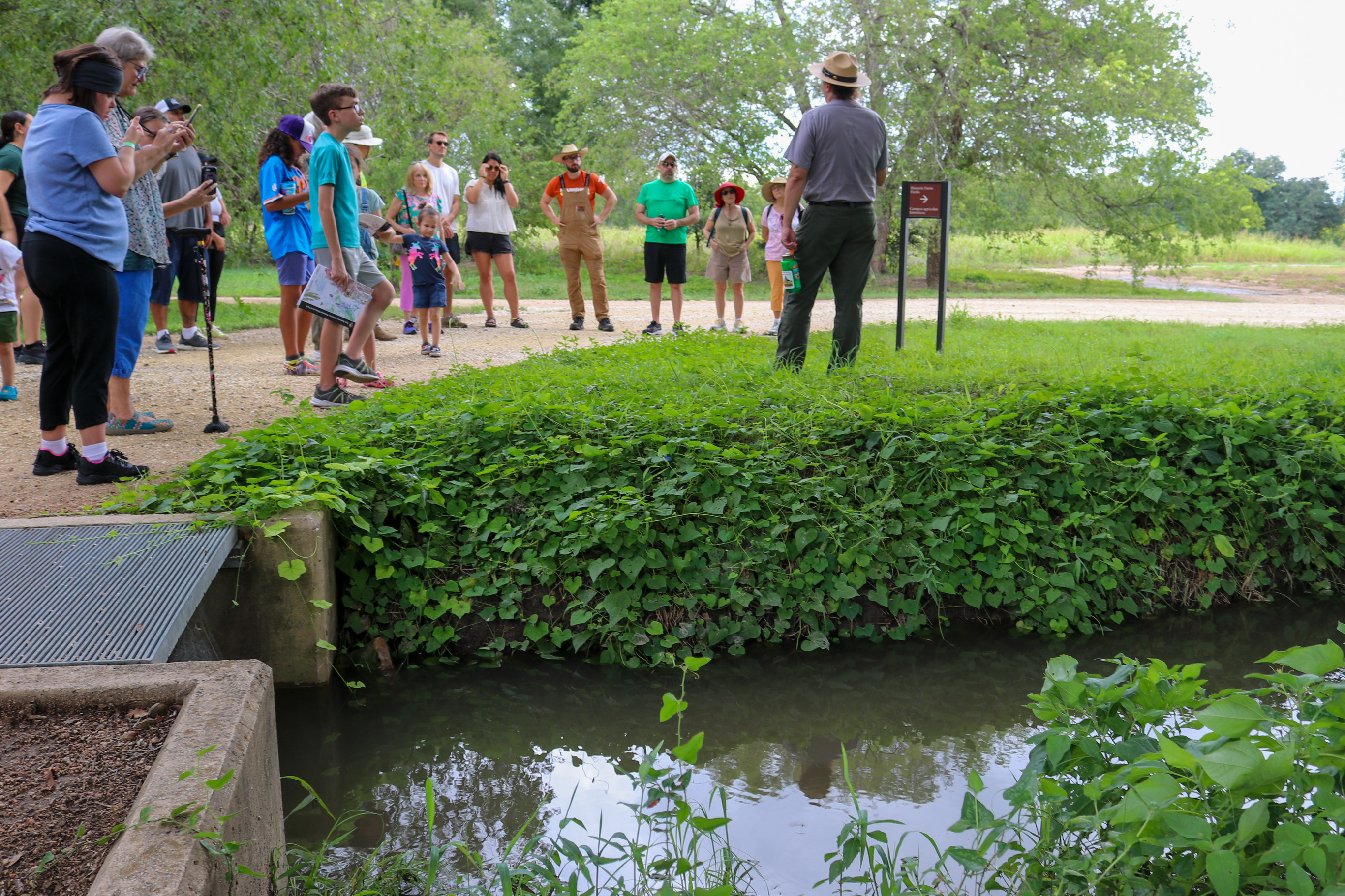 group standing in front of a historic acequia