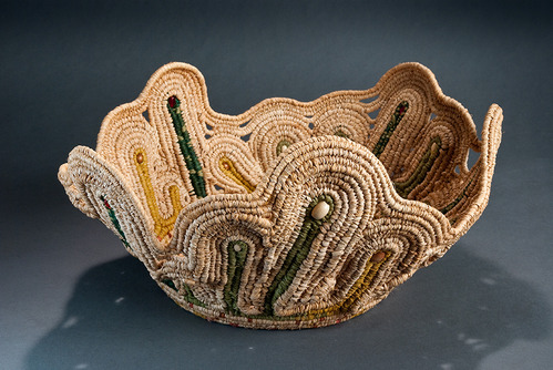 Hand-made basket from HOSP 2009 Artist-in-Residence Donna Dunnahoe, entitled "Natural Hot Springs"; donated to park Superintendent Josie Fernandez; fired stoneware bottom, hand-woven rafia upper with colored beads; irregular shape; tan, green, yellow, pink.