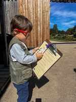 A child holds a clipboard. 