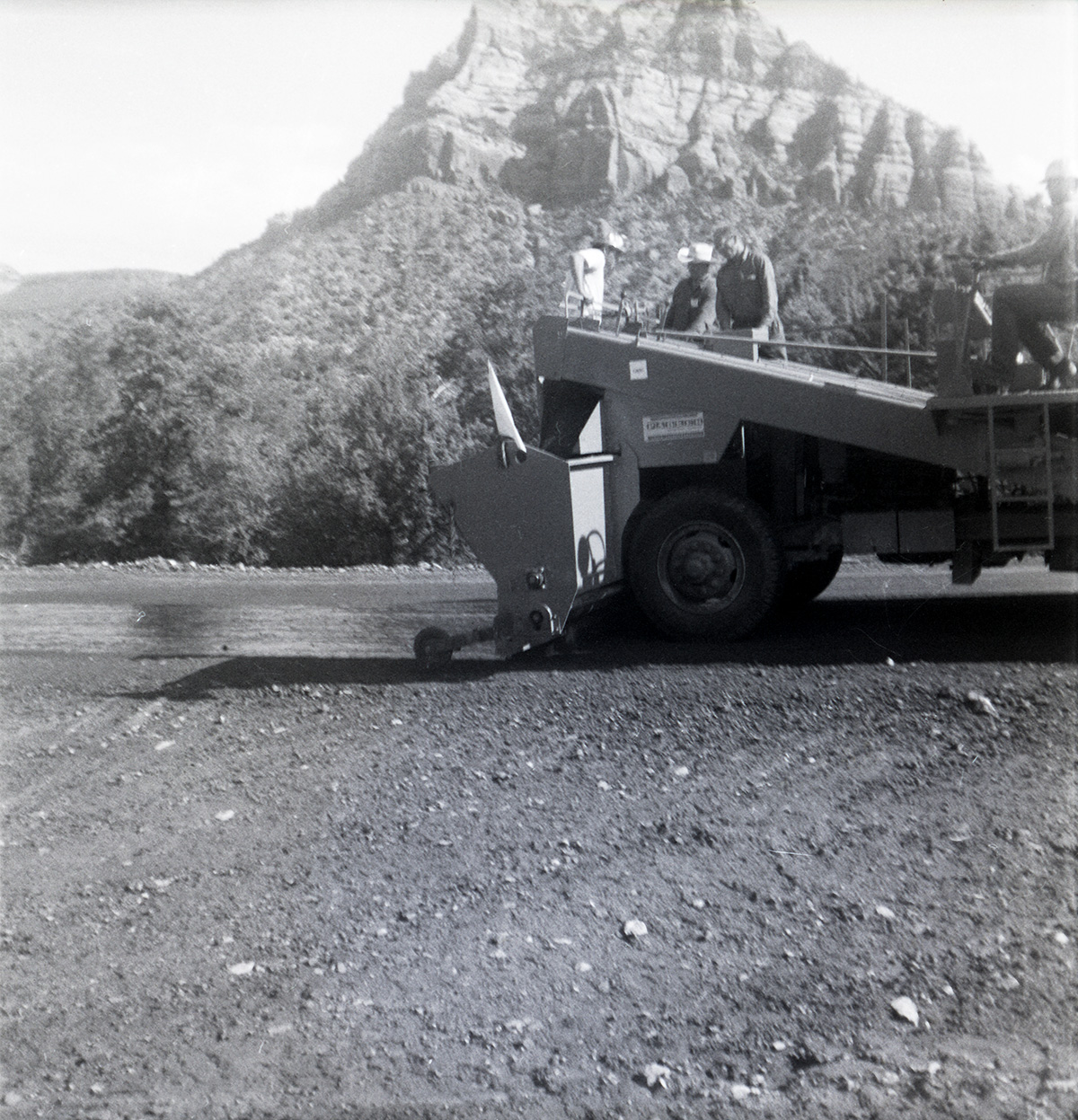 Men operating construction vehicle during chipsealing of Kolob Canyon Road.