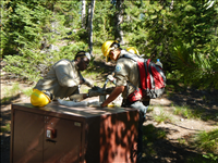 Yellowstone YCC installing a Food Storage Box (Bear Box) at Norris Campground in Summer 2014.. Yellowstone YCC enrollees installing a bear box at Norris Campground in Summer 2014. Each campsite now has a bear box for campers to store their food, coolers, and stoves.
