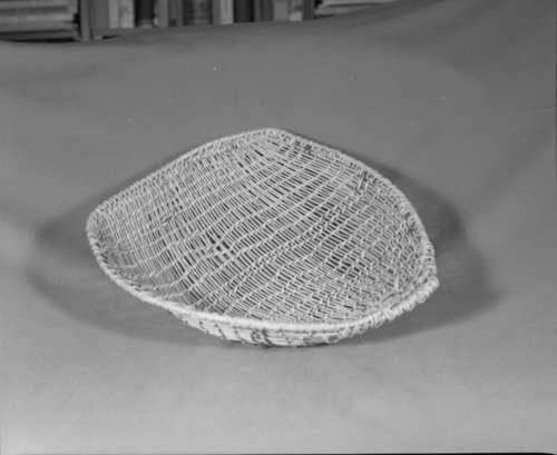 Private Collection. Object: Miwok basket. Dimensions: 15 x 13 x 3". Materials: Ceanothus cuneatus shoots, split and split redbud. Technology: Diagonally twined, up to right slant of turns, splices rather hastily done, overlapping strands sometimes for three inches. One splice rewoven. No alternate slants of turns of twining & one row of three strand twining two inches below selvedge, rimstick attached with the aid of an awl & overlapped at start. Collection History: From Angels Camp. Photographed by Michael Dixon. Catalogued by Craig Bates and Barbara Beroza. Yosemite Collections, National Park Service.