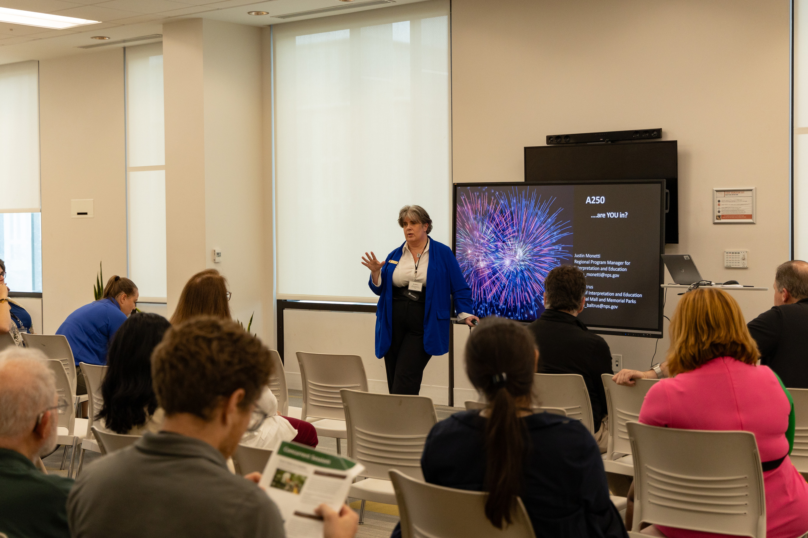 a woman presents in front of a classroom