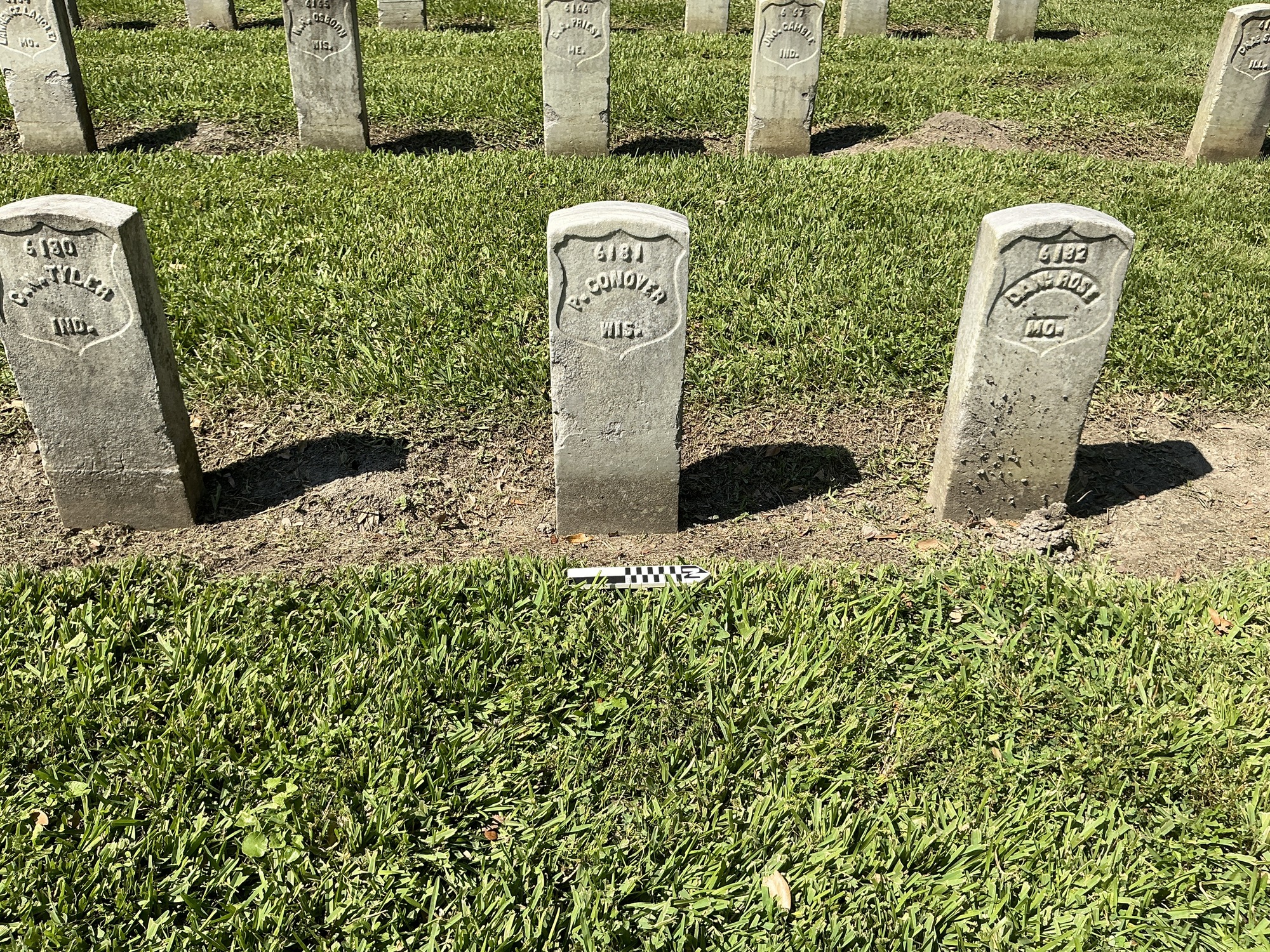 Extra image of historic upright marble headstone with recessed shield face.