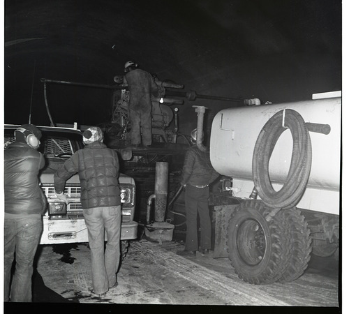 Worker works with drill rig during test hole drilling in Zion-Mt. Carmel tunnel.