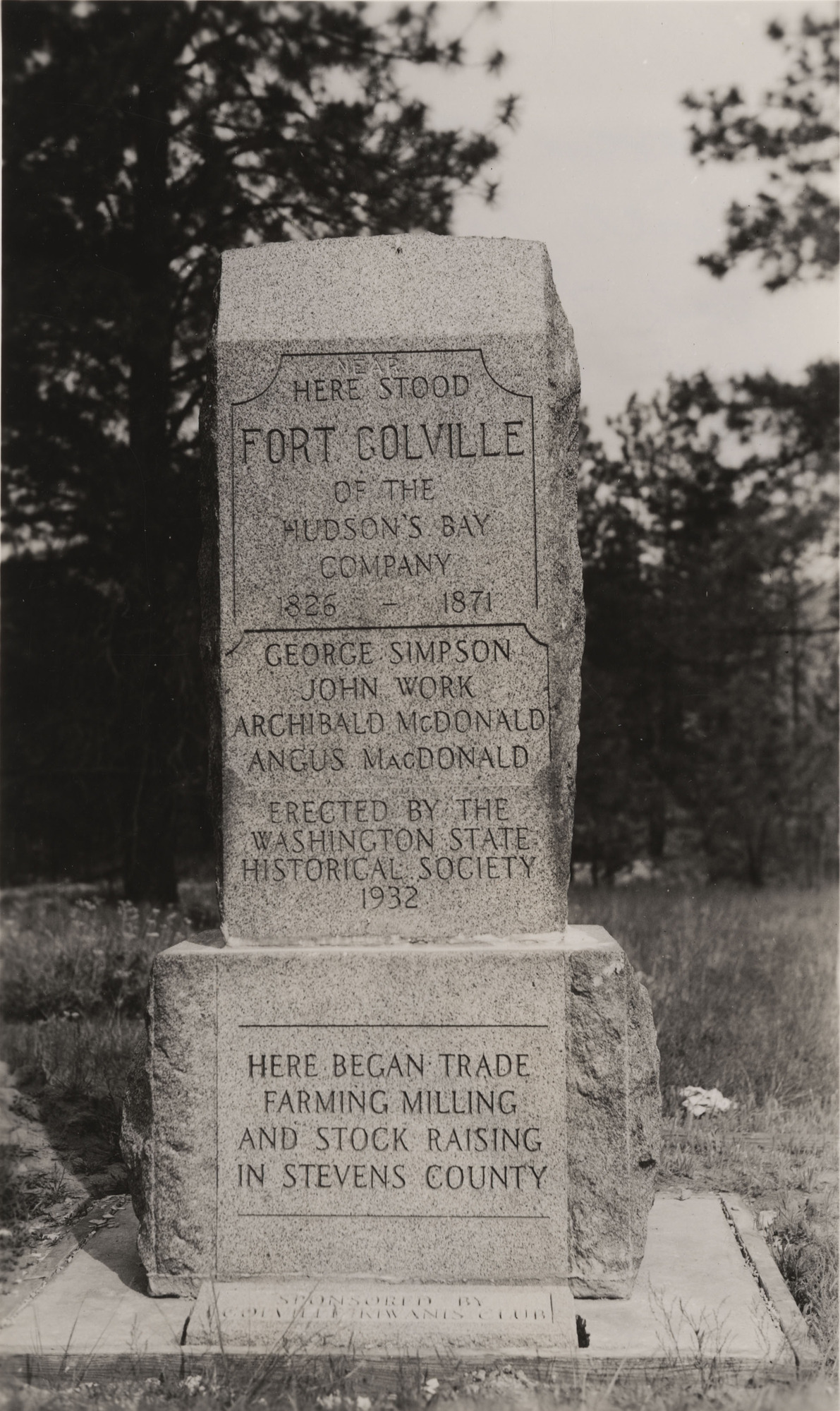 Black and white photograph of two tiered engraved stone monument