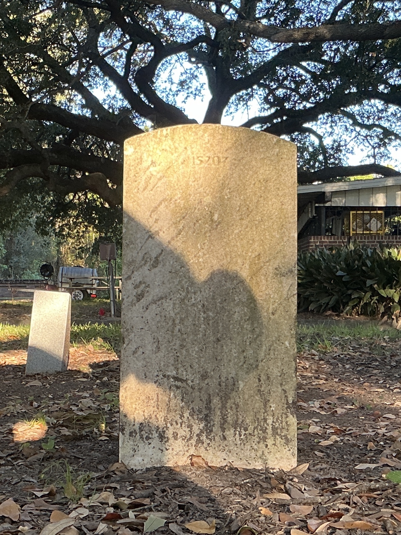 Back of upright marble headstone with flat face.