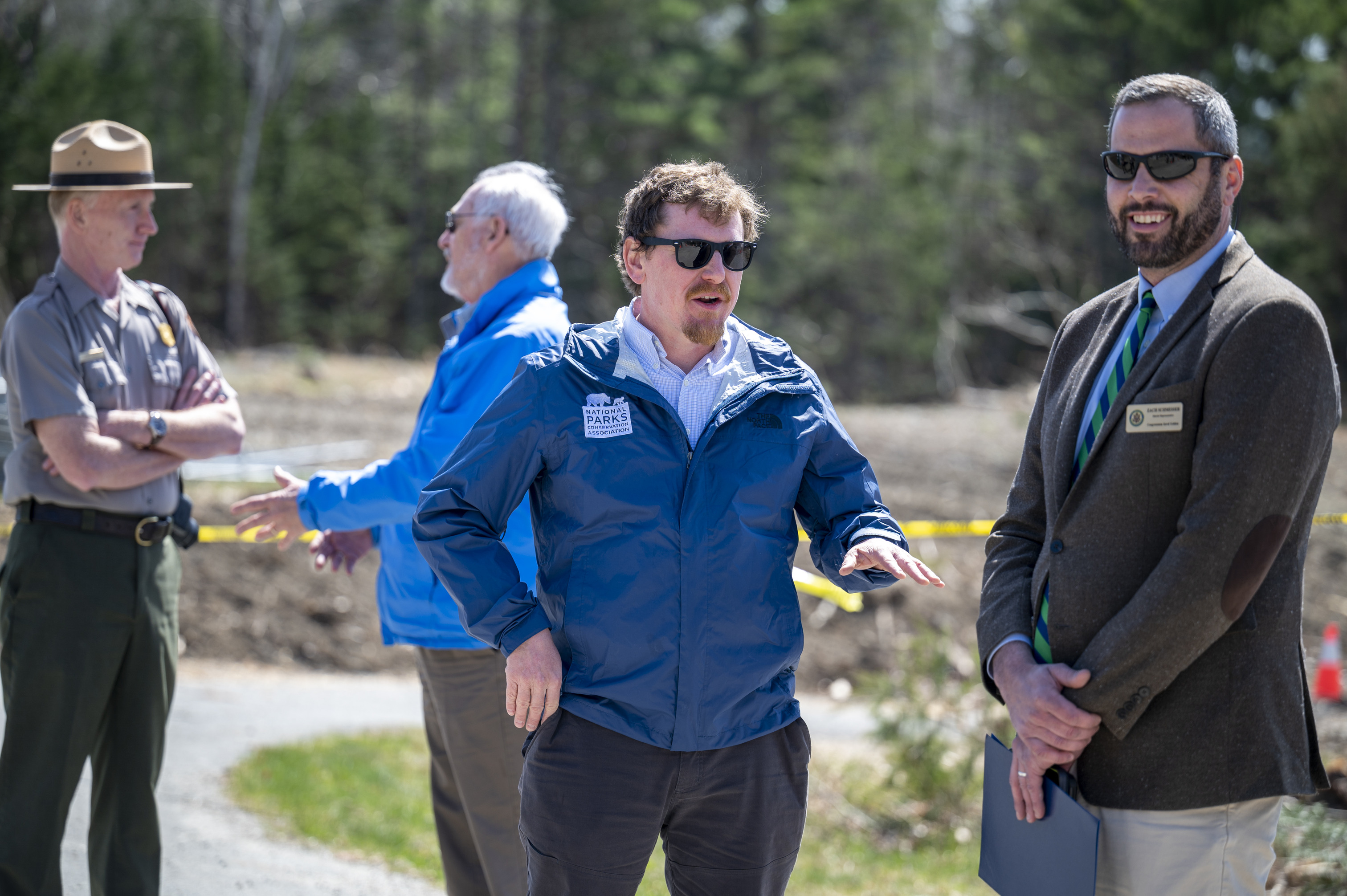 Four individuals engage in two separate conversations.
