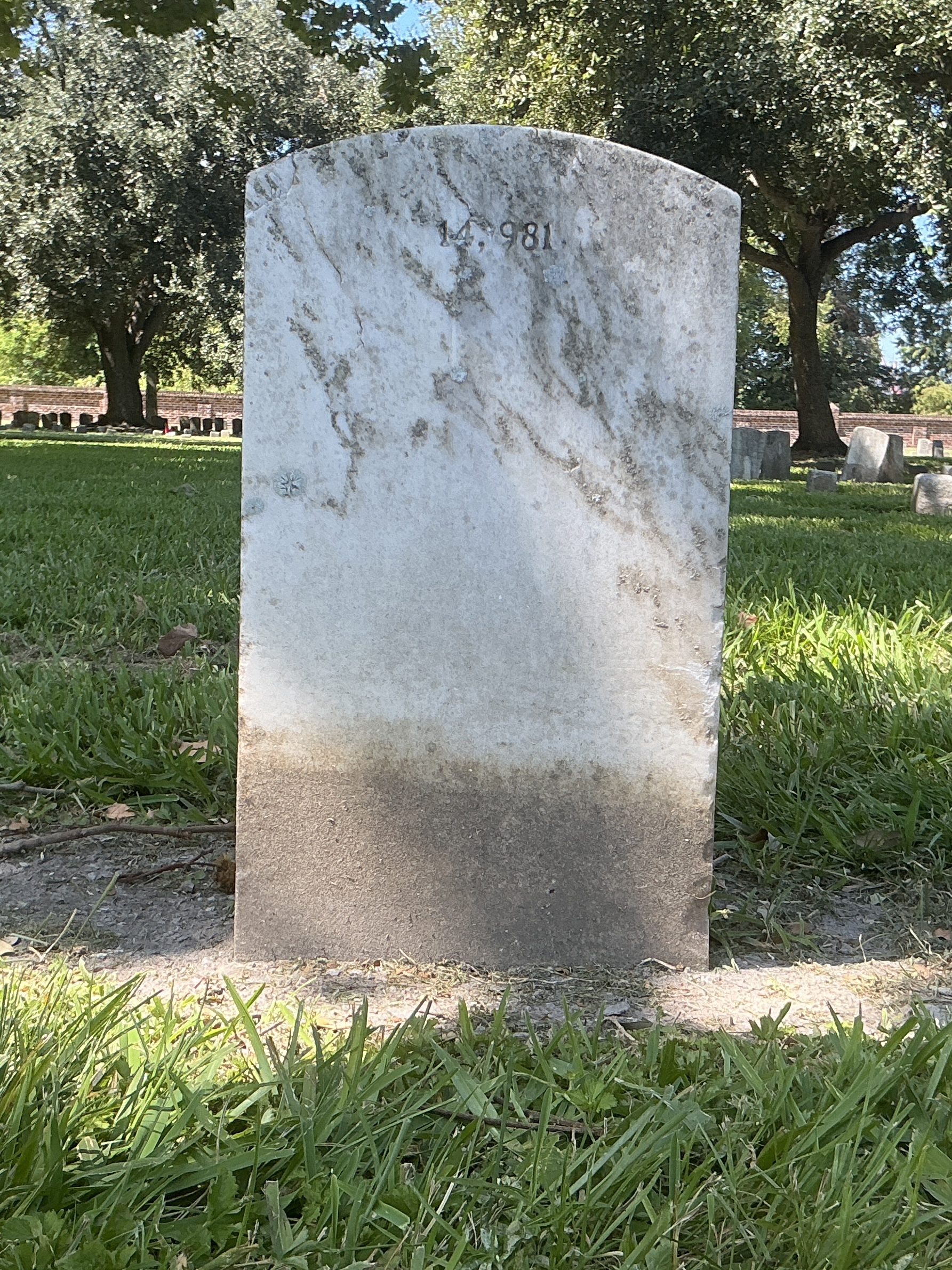 Back of upright marble headstone with flat face.