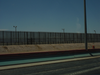 A fence on the side of a road.