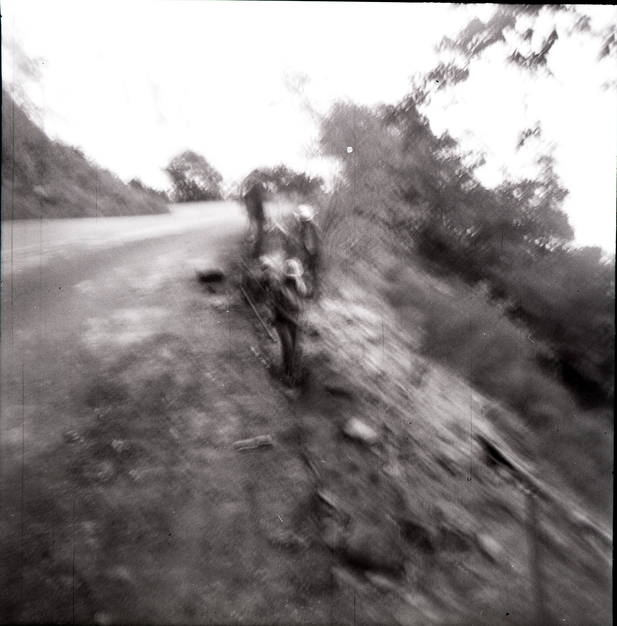 Men working on rebuilding rock retaining wall alongside road at Zion-Mt. Carmel Highway tunnel.