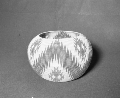 Mrs. Donald Segerstrom Collection. Object: Paiute basket. Dimensions: 13 x 8 1/2". Materials: sedgeroot, bracken fern, redbud, willow. Technology: interlocking stitch, overstitched rim worked opposite direction, fag ends trimmed on work face, moving ends trimmed on interior, some stitches occasionally split on interior particularly in upper portion. Photographed by Michael Dixon, January 1983. Catalogued by Craig Bates and Barbara Beroza. Yosemite Collections, National Park Service.