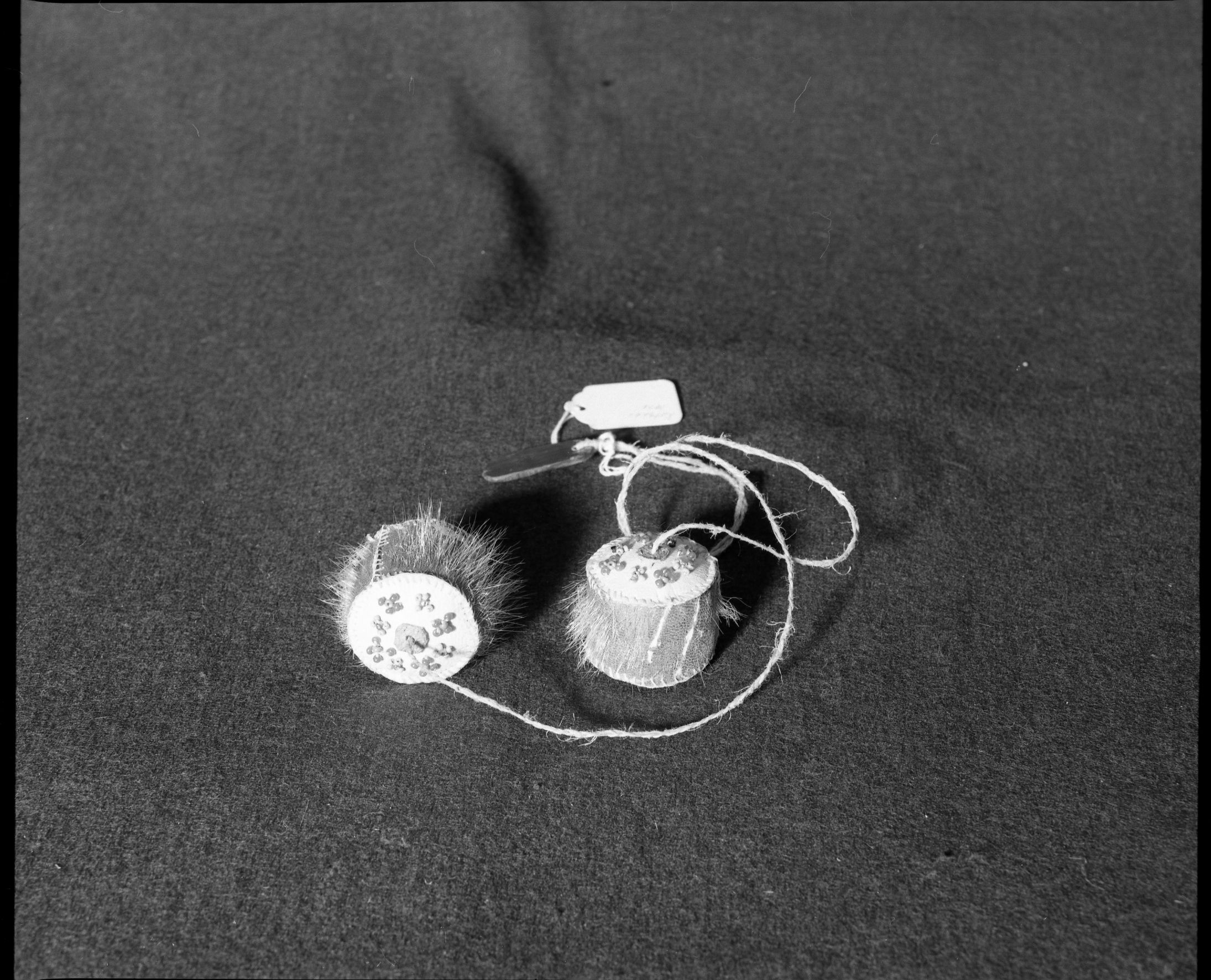 Marie Rozier Collection. Object: Eskimo yoyo. Dimensions: 1 1/2" diameter ball. Materials: seal fur, braided sinew, glass beads, thread, baleen. Collection History: Made by Bessie Kowunno. Purchased in Kotsebue in 1976. Photographed by Michael Dixon, December 1982. Catalogued by Craig Bates and Barbara Beroza. Yosemite Collections, National Park Service.
