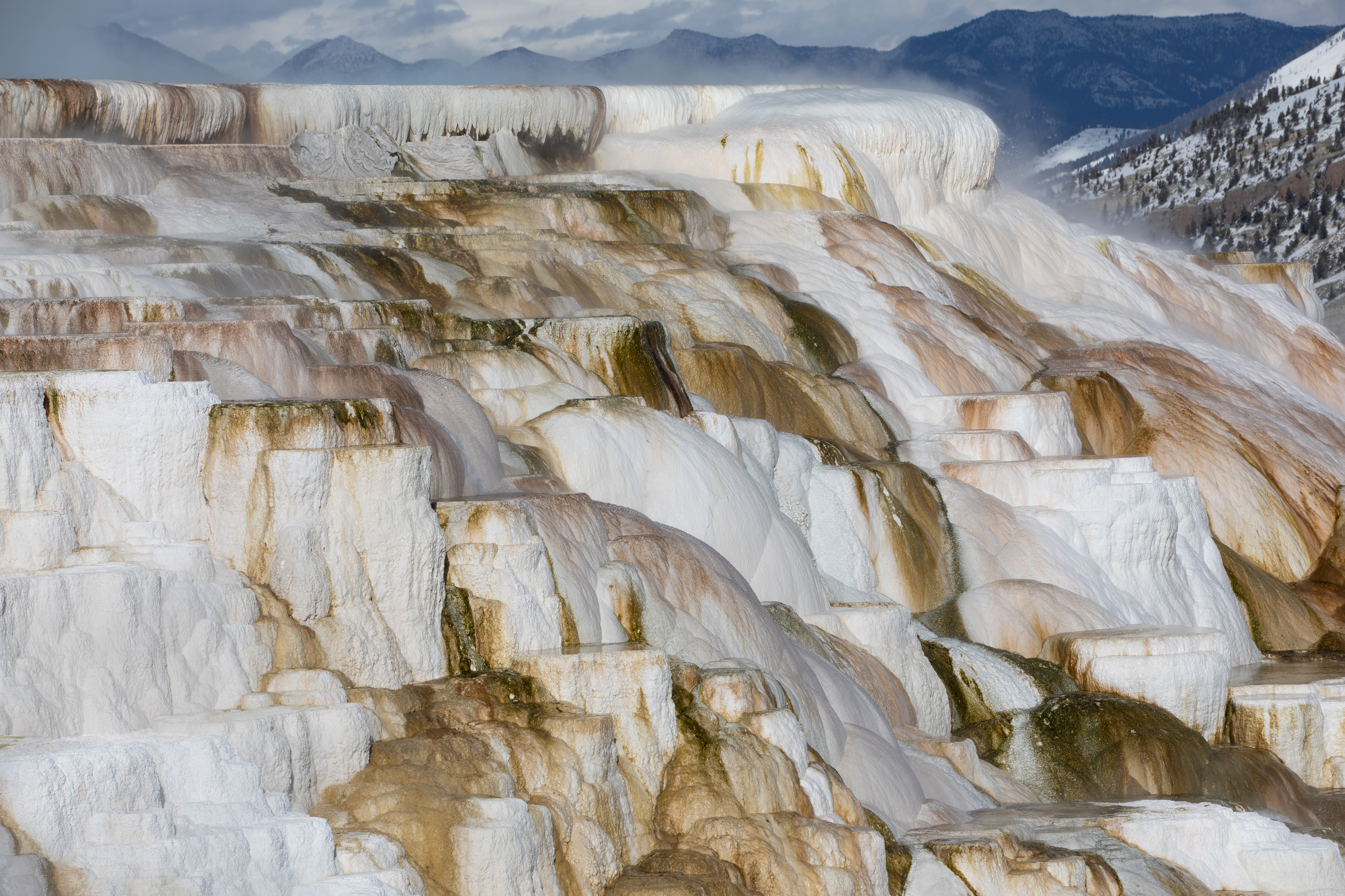 Hot water flows over travertine terraces.