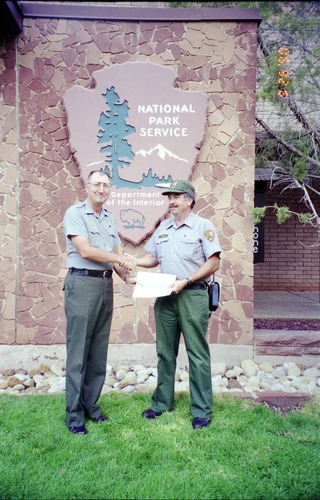 Color Photos of Superintendent Harold Grafe giving out awards to park personnel.