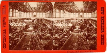 the photo is on red cardboard and it is the inside of a hall filked with vegetation. 