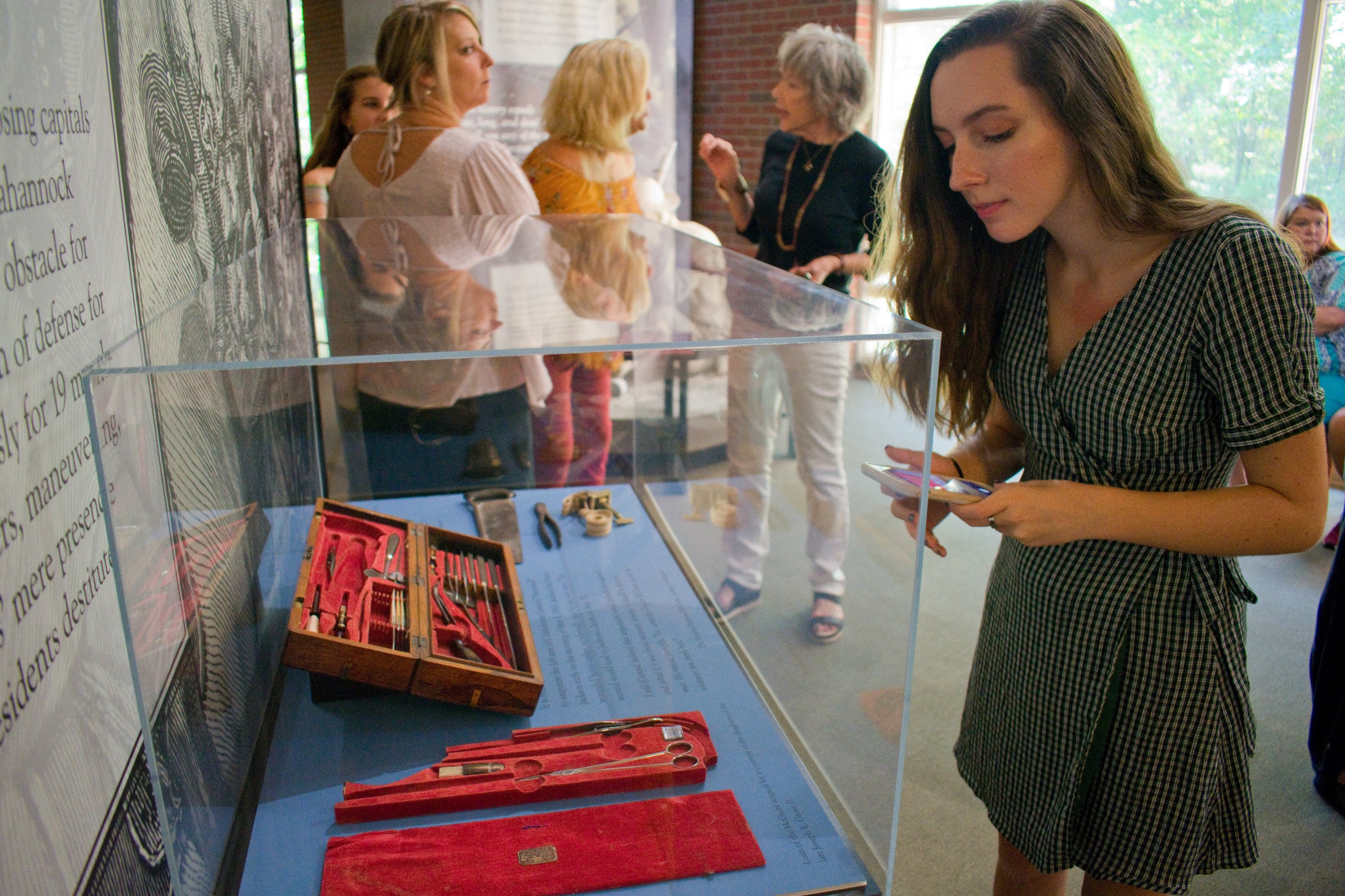 People looking in an exhibit case.