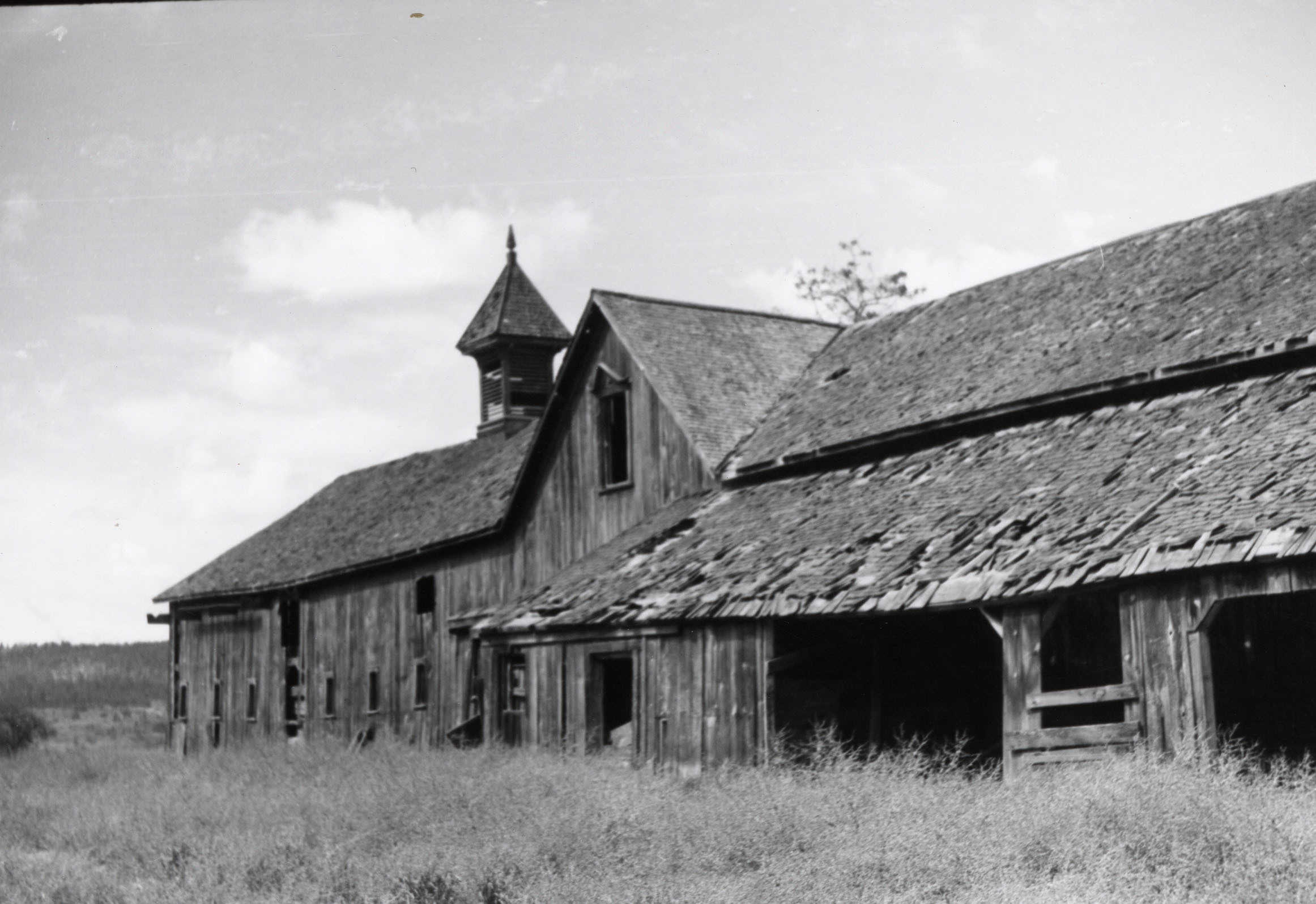 Black and white photograph of dilapidated barn