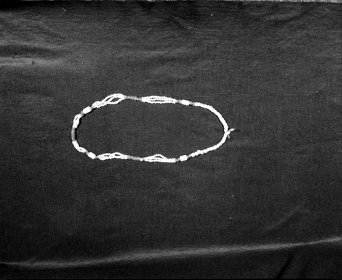 Marie Rozier Collection, Catalog No. 143. Object: Strand of trade beads. Dimensions: 32" strand. Materials: Opaque white glass paste beads, variants of Cornaline d'Aleppo. Collection History: Mid to late 19th Century type, collected from village sites in Tuolumne by Ed and Helen Jasper. Gift of the Jaspers. Photographed by Michael Dixon in December 1982. Catalogued by Craig Bates and Barbara Beroza. Yosemite Collections, National Park Service.