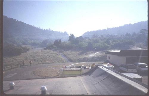 Firefighters provide structural protection to commercial buildings during the Bircher fire, Mesa Verde National Park, July 2000