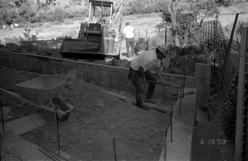 Worker placing rods during the construction of headquarters addition.