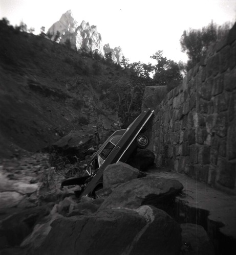 BW photo of a car that went off the road into the Virgin River.