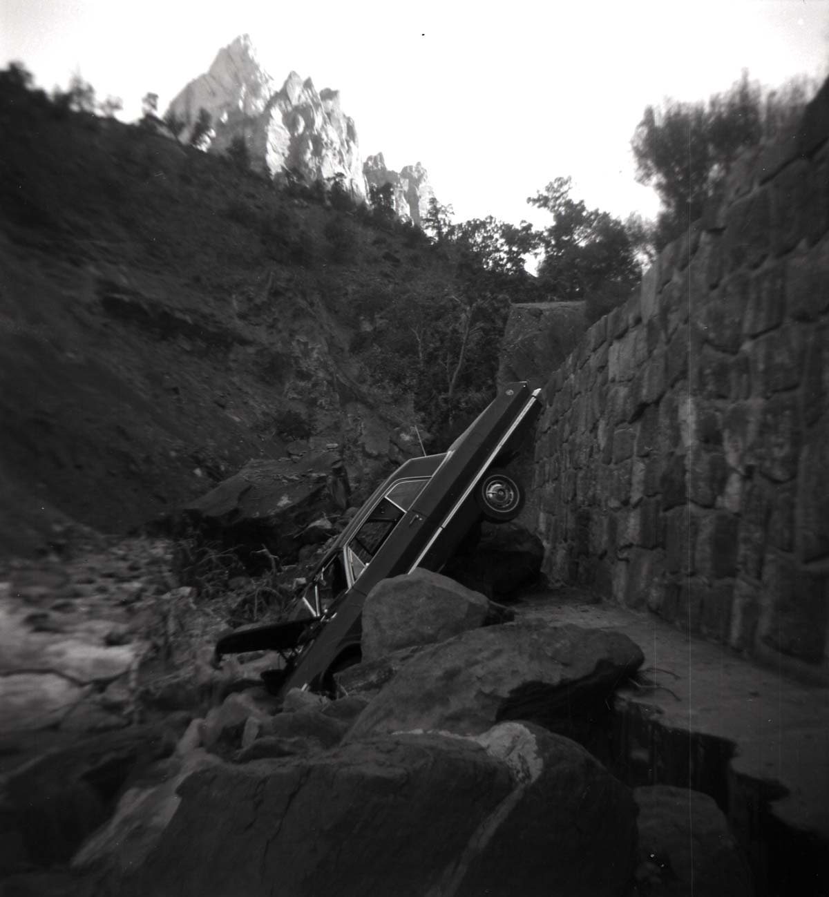 BW photo of a car that went off the road into the Virgin River.