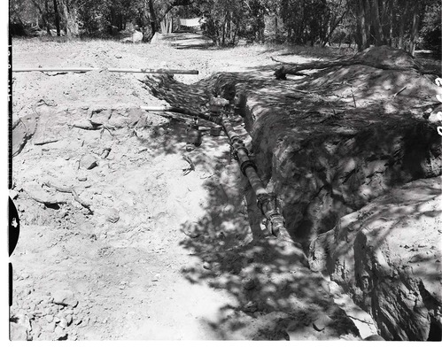 Water supply system - mouth of Birch Creek- excavating trench for water line.