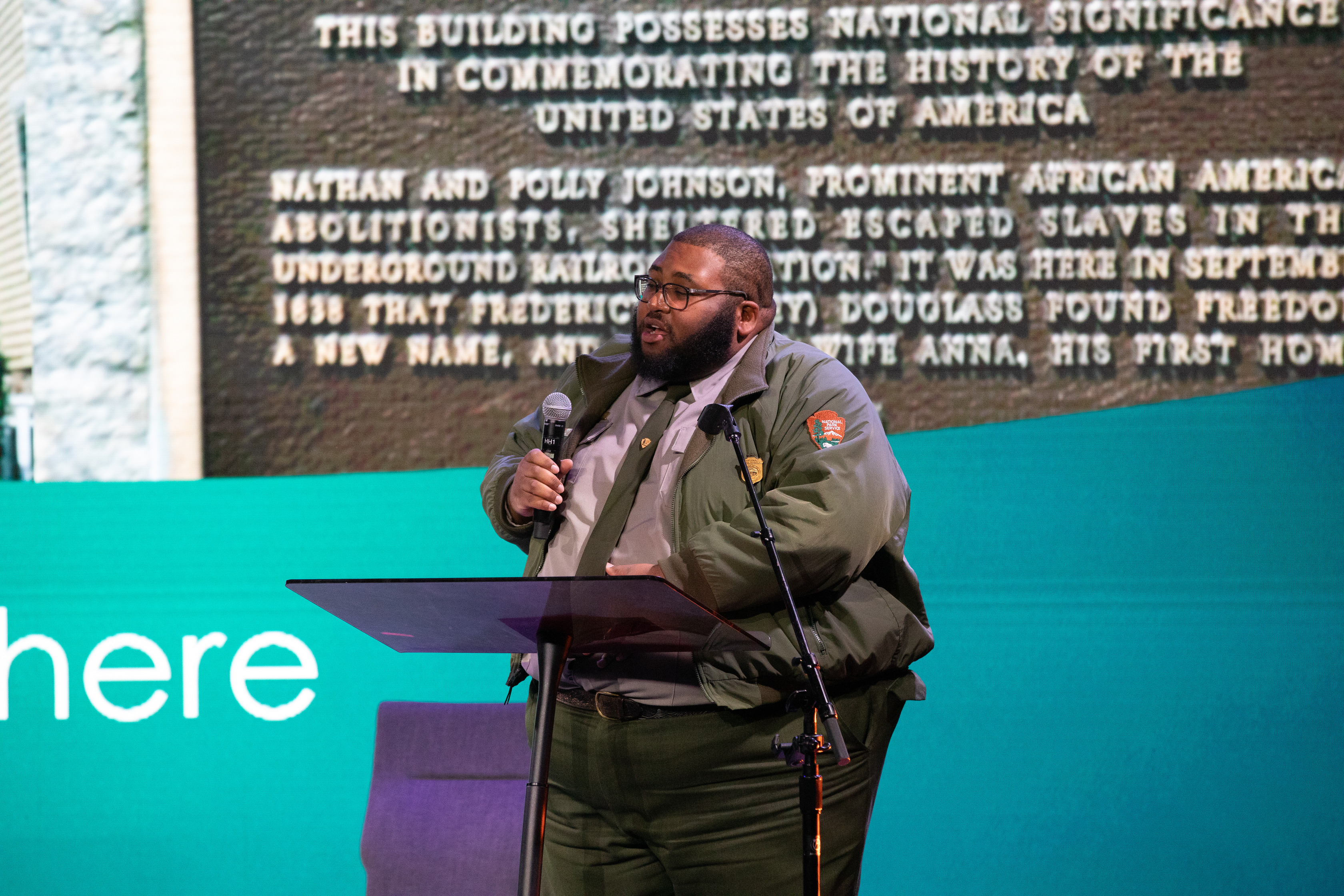 A park ranger gives a speech at a podium
