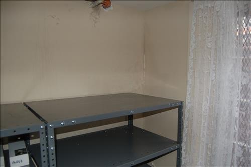 Water infiltration and damage to walls and floor of the Petersen House