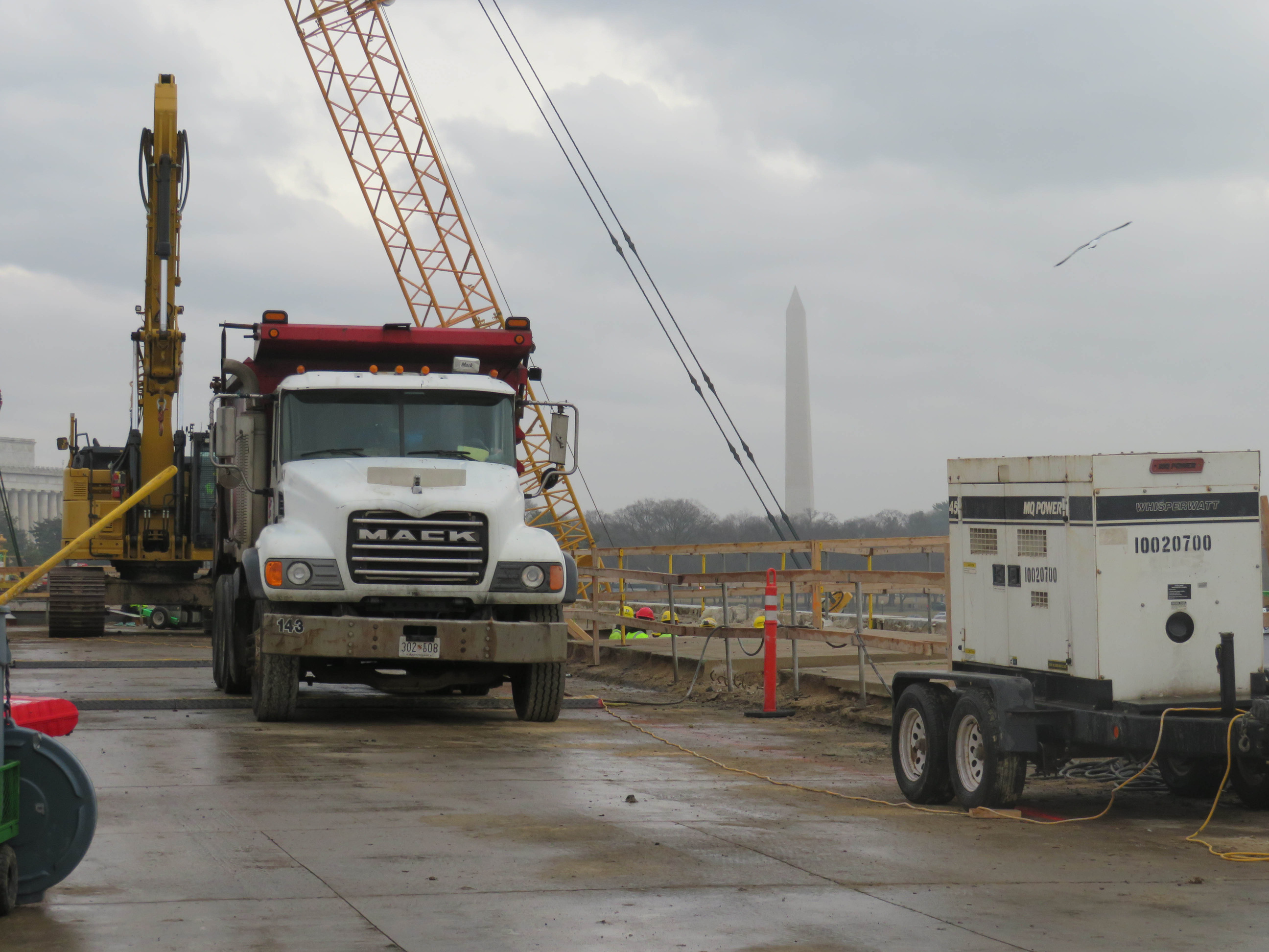 Construction and cranes on Arlington Memorial Bridge on a cloudy, rainy day. 