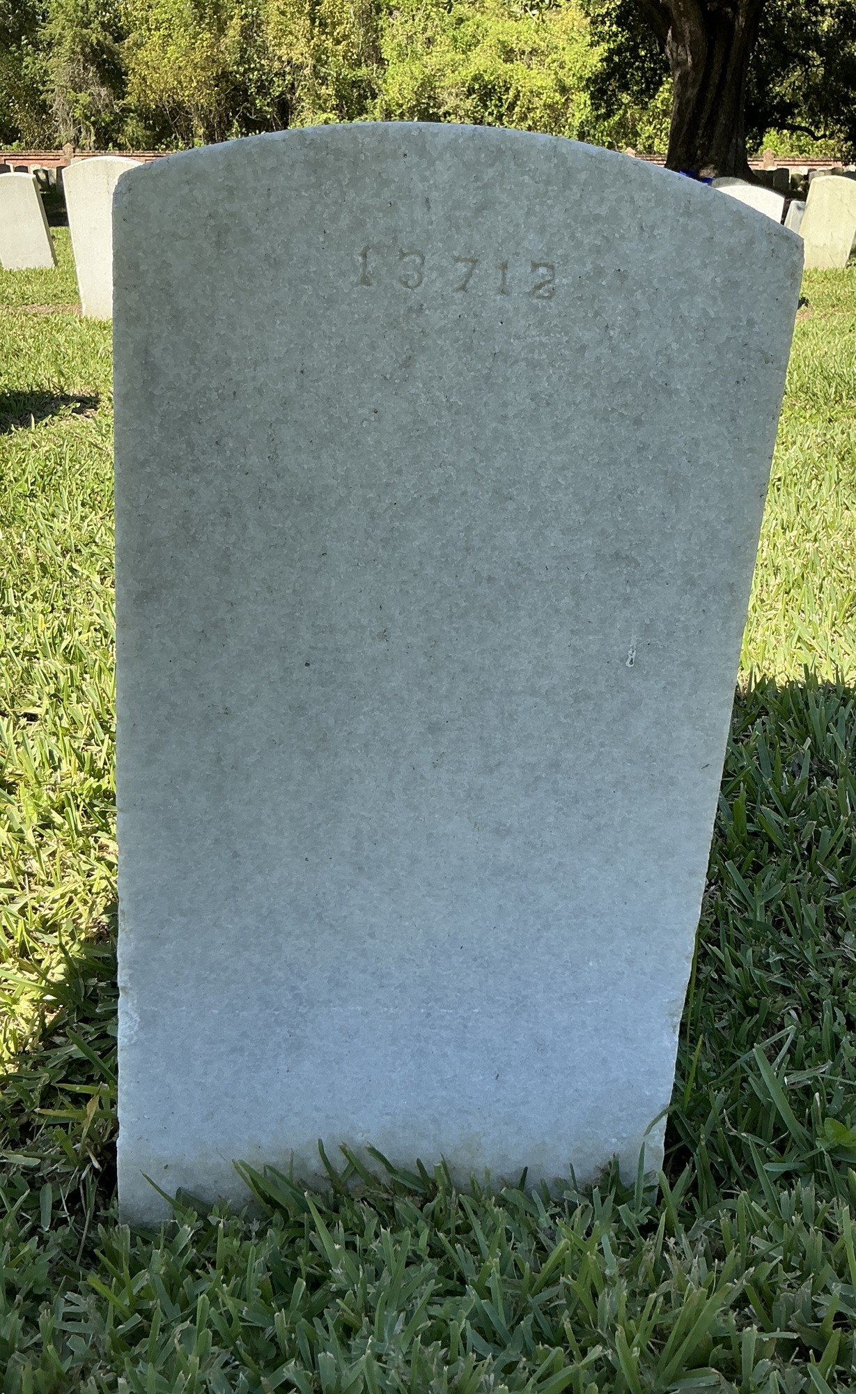 Back of upright marble headstone with flat face.