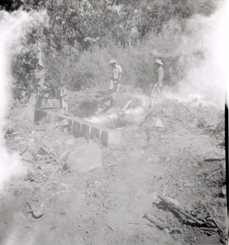 Park personnel installing a culvert/drainage pipe in location in Zion.