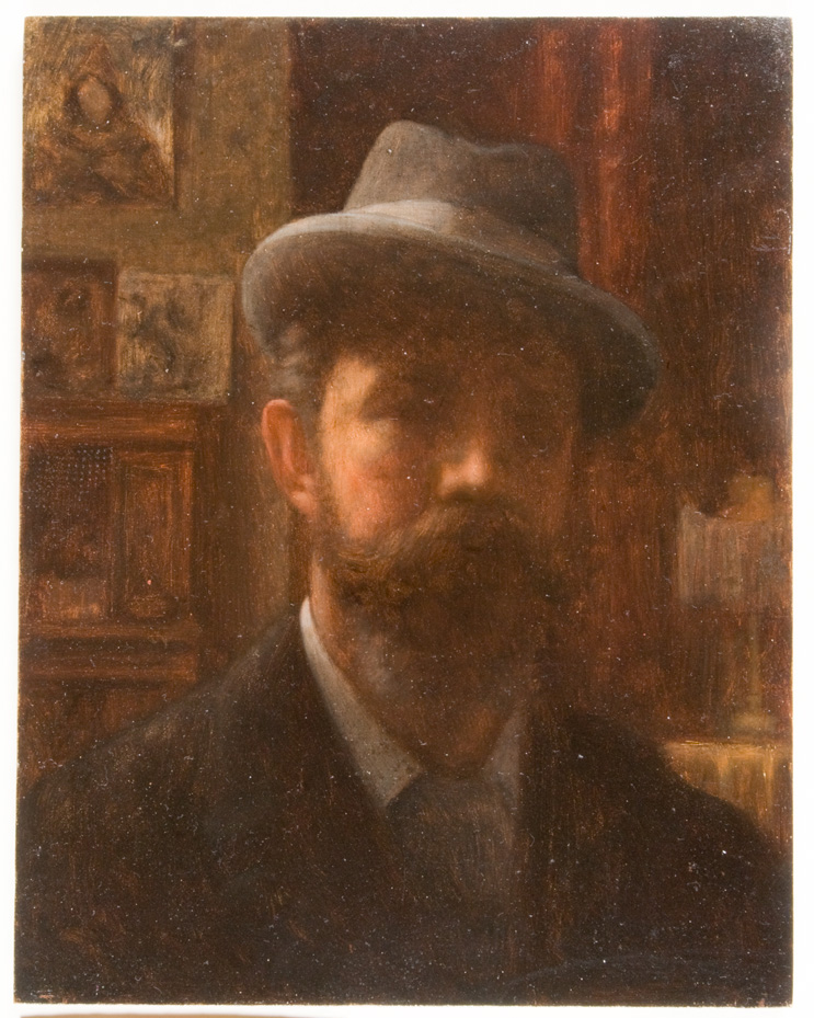 Portrait of man with large mustache and fedora hat in interior